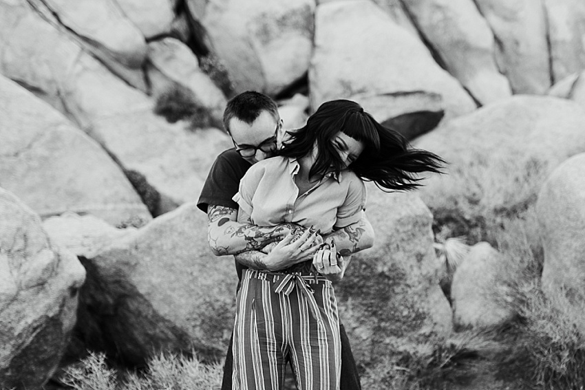 tattooed couple embracing and swaying in joshua tree california