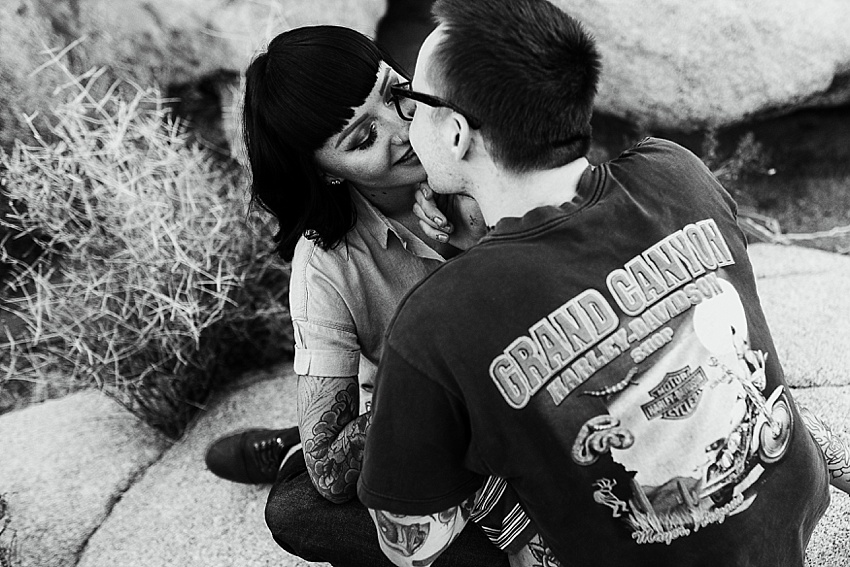 tattooed couple sitting and kissing joshua tree national park