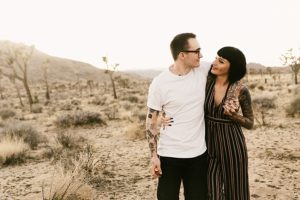 guy with arm around girl engaged in joshua tree national park