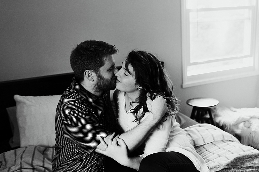 couple kissing on bed in home muncie indiana photography