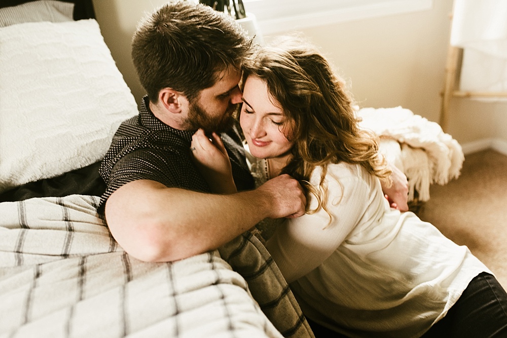 couple kissing on bed in home muncie indiana photography