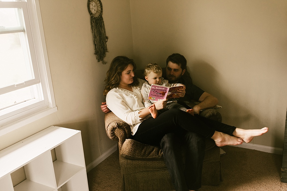 family reading in nursery chair in muncie indiana photography