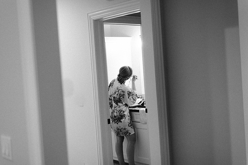 Black and white photo of bride getting ready.