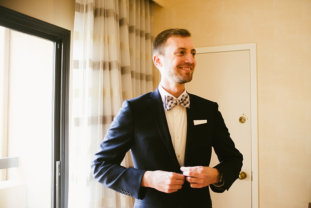 groom-buttoning-tux-for-his-chicago-wedding