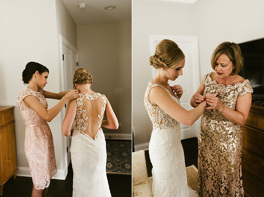 Black and white photo of mother of the bride helping bride get dressed.