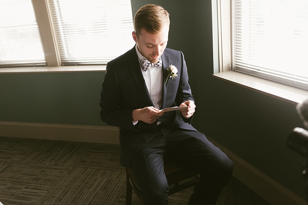 groom reading letter on his metropolis ballroom wedding day