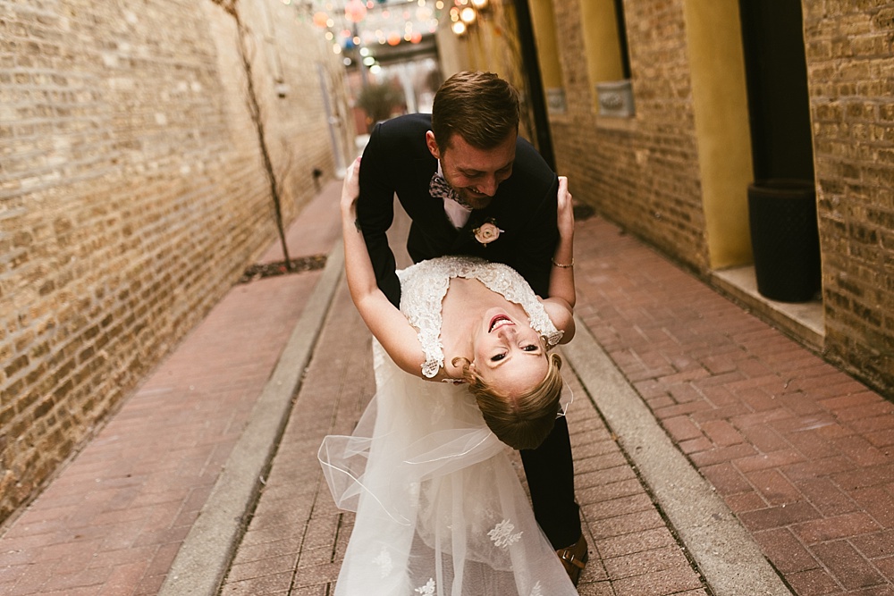 bride and groom dancing in chicago alleyway