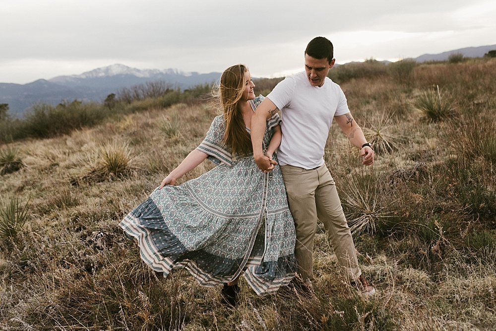 girl swishing dress and holding husbands hand at palmer park colorado springs
