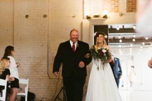bride and dad walking down aisle at coppes commons indiana