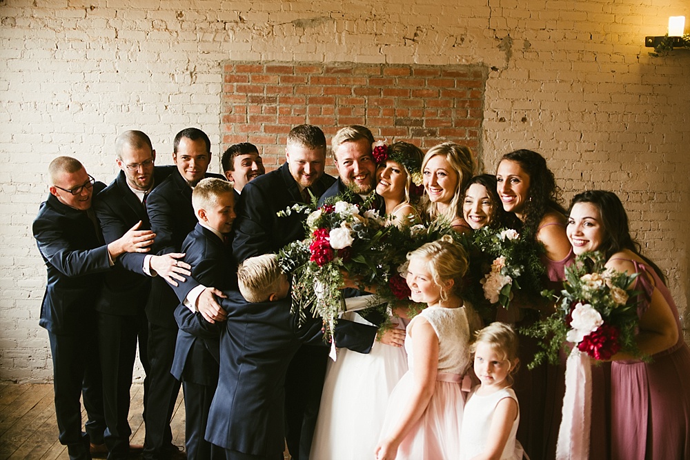 bridal party hugging at coppes commons indiana