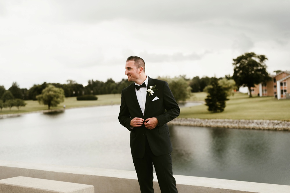 groom buttoning tux at concordia lutheran seminary