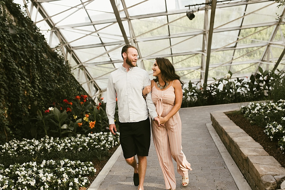 couple walking through botanical gardents
