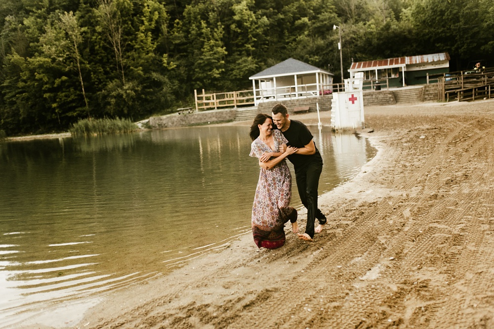 couple running along beach during engagement session at france park