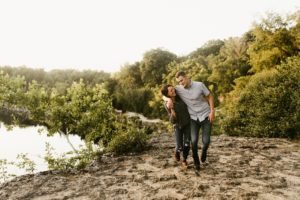 couple walking along cliff during engagement session at france park