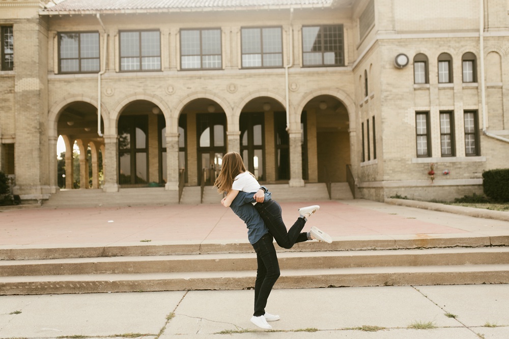 guy lifting girl up at belle isle detroit engagement session