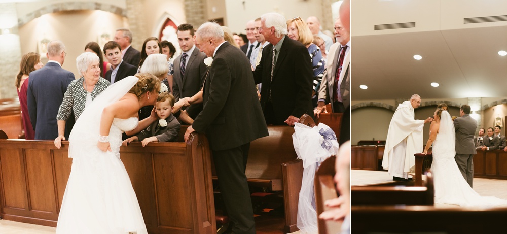 bride kissing son during wedding cermony at st. anthony's catholic church