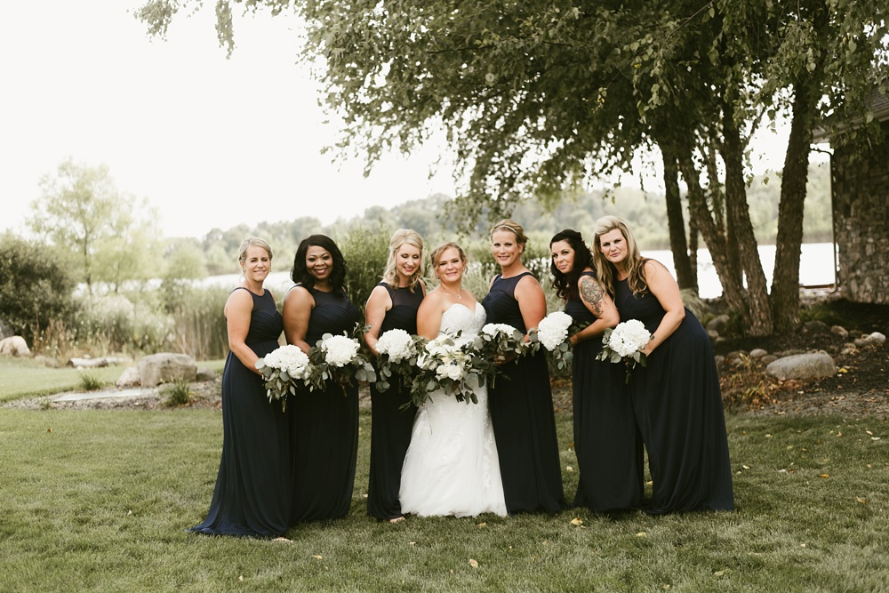 bridal party in navy dresses with bride at glendarin golf course
