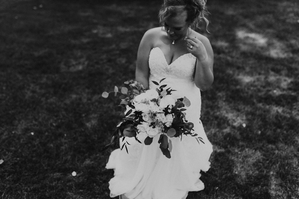 bride in a-line dress with white rose bouquet at glendarin golf course