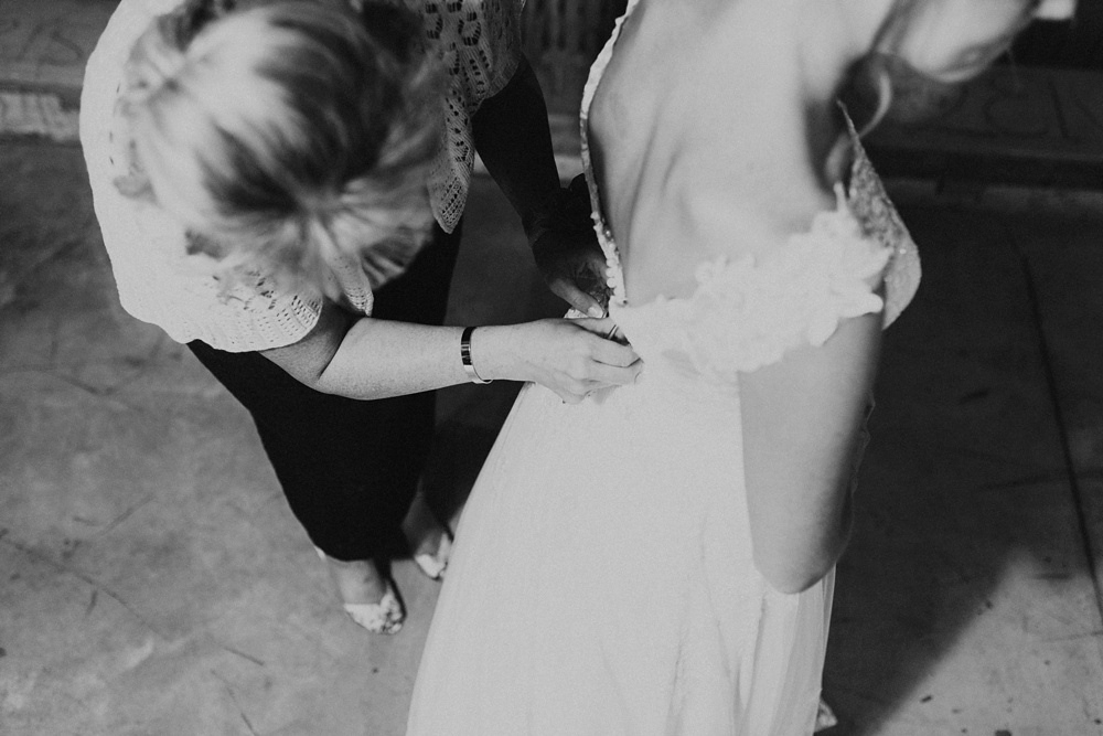 mother of bride buttoning dress from one fine day at j weaver barn wedding