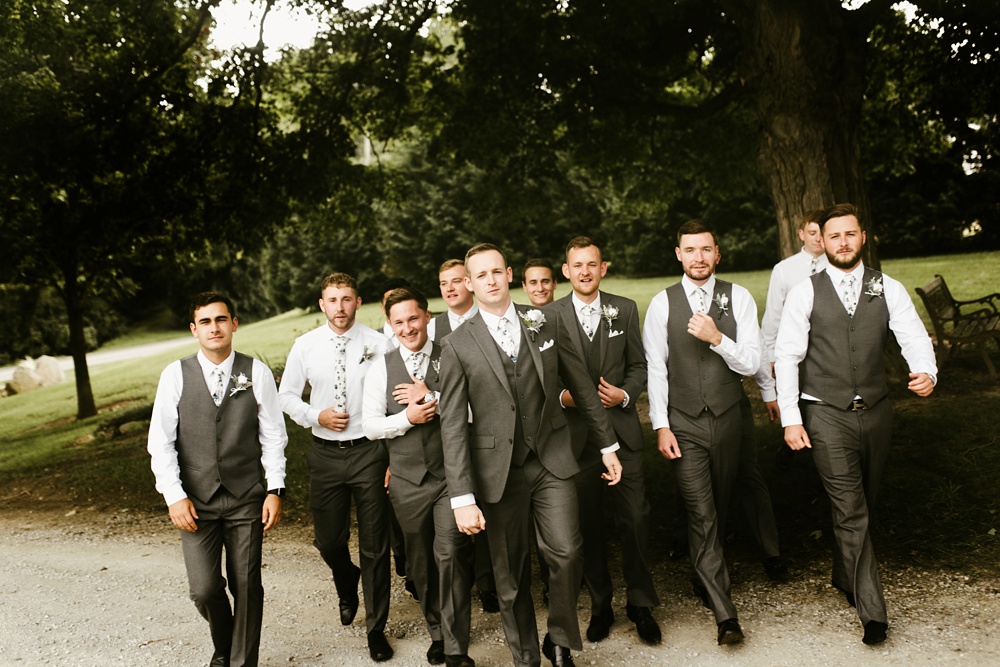 groomsmen walking with groom at j weaver barn wedding