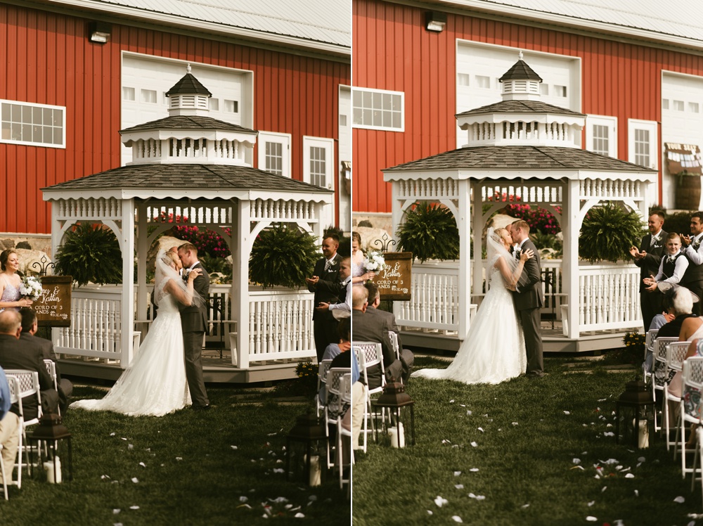 bride and groom first kiss under gazebo at j weaver barn wedding