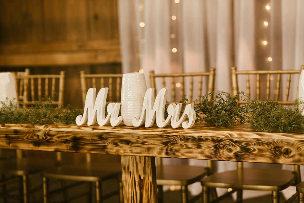 Mr. and Mrs. at head table at j weaver barn wedding