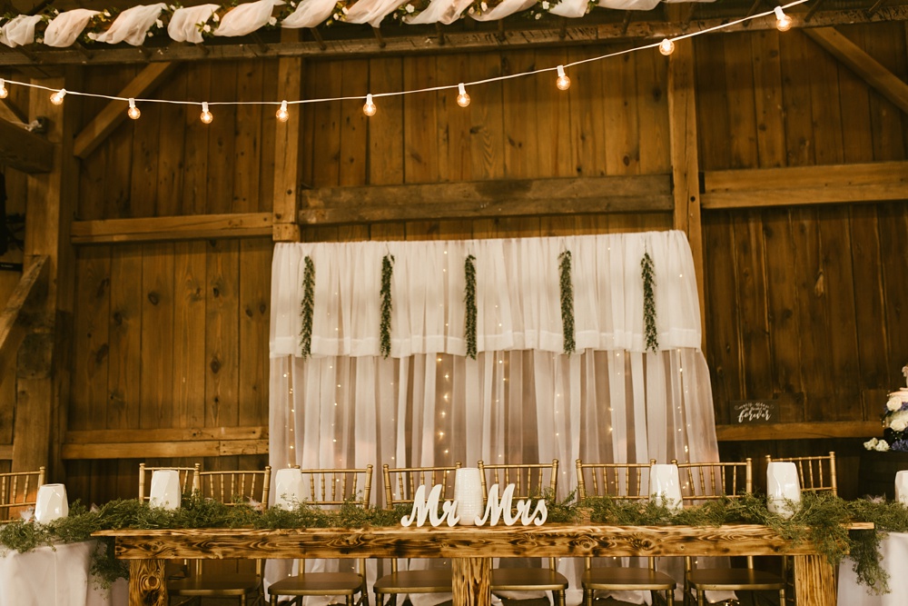 head table, candlelights and backdrop at j weaver barn wedding