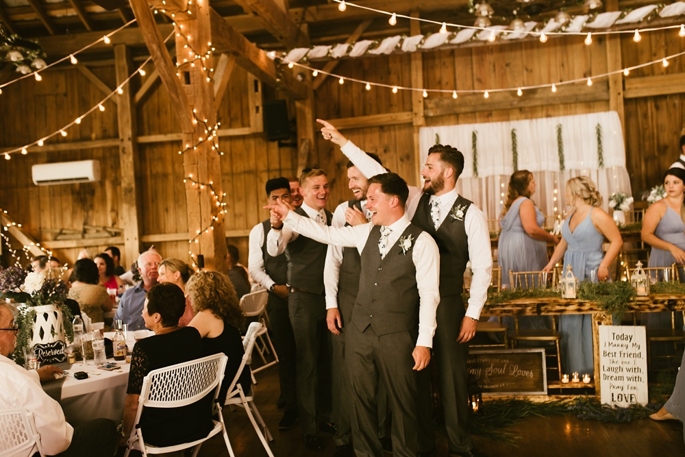 groomsmen entering reception at j weaver barn wedding