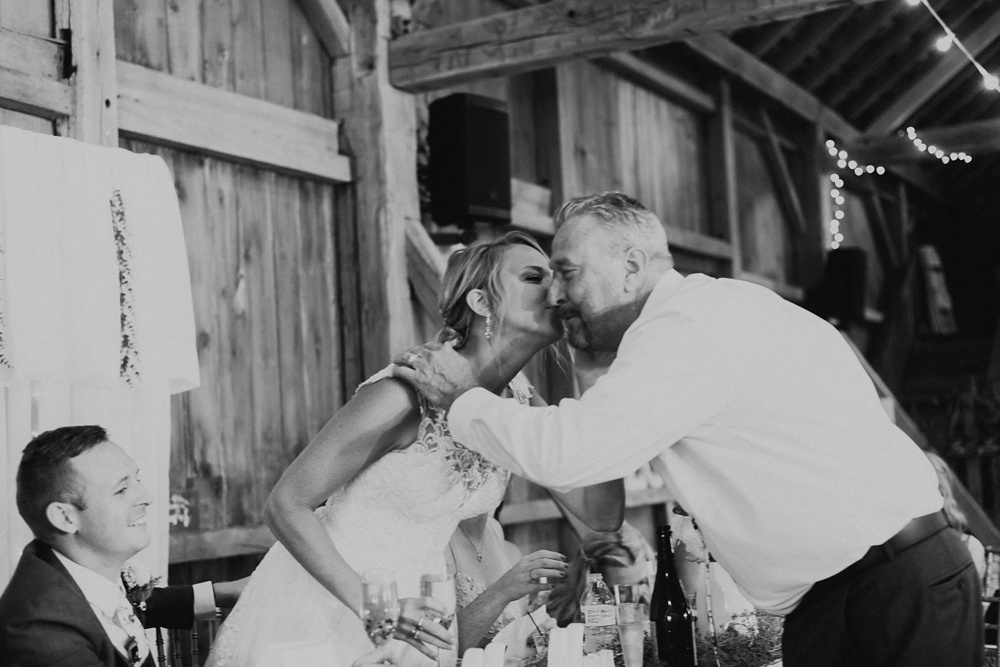 bride kissing fathers cheek at j weaver barn wedding