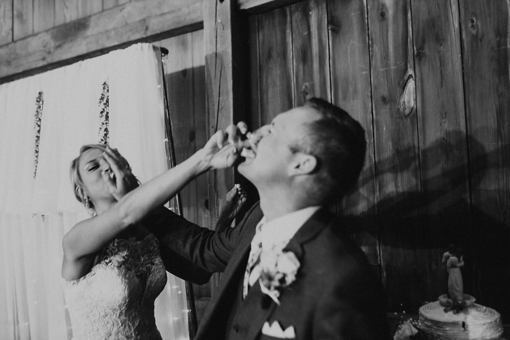 bride and groom smashing cake at j weaver barn wedding