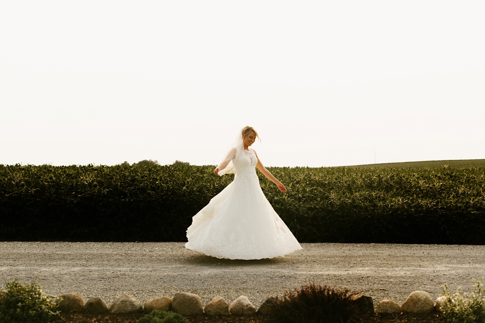 bride twirling in one fine day dress at j weaver barn wedding
