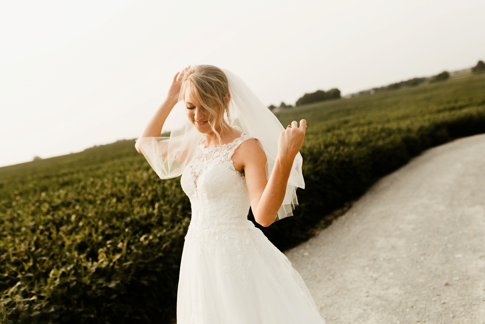 bride in lace detail dress from one fine day at j weaver barn wedding