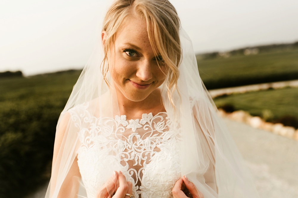 bride in lace detail one fine day dress smiling at j weaver barn wedding