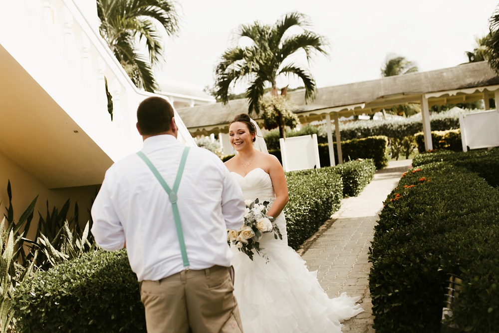 bride and groom first look ceremony in courtyard at grand palladium jamaica wedding
