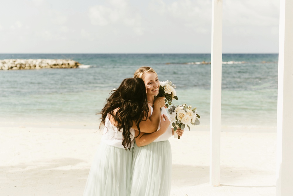 bridesmaids in seafoam tulle skirts and white express tops at grand palladium jamaica wedding