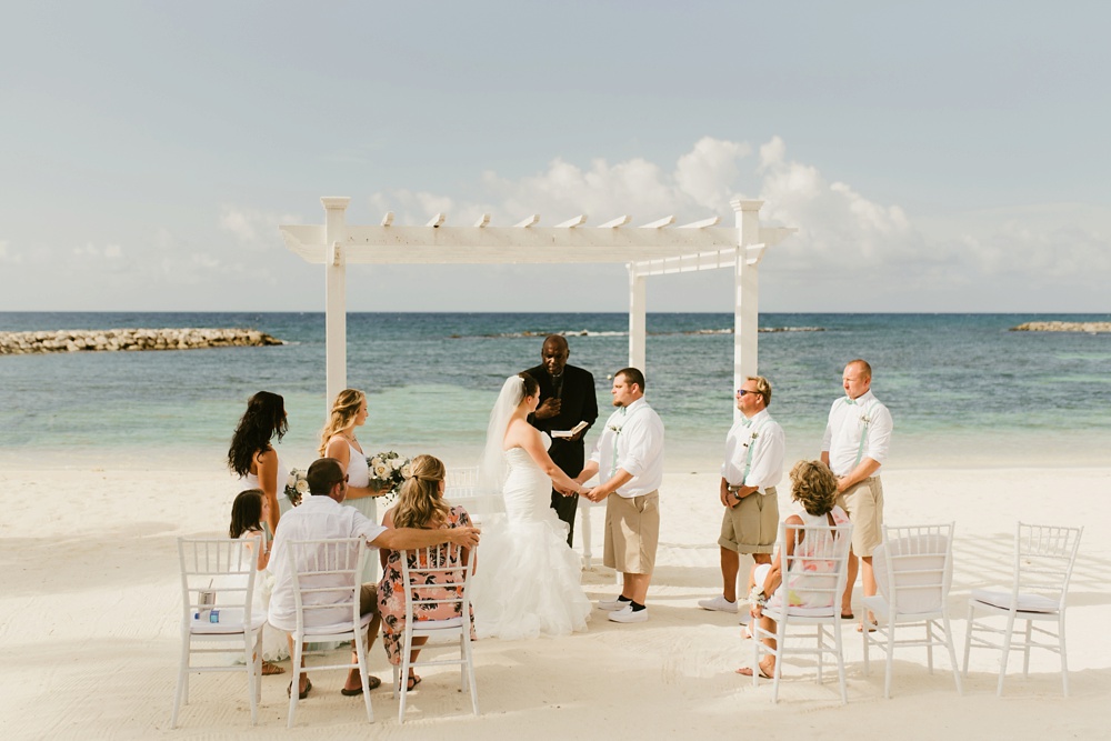 bridal party and bride and groom at beachside ceremony at grand palladium jamaica wedding