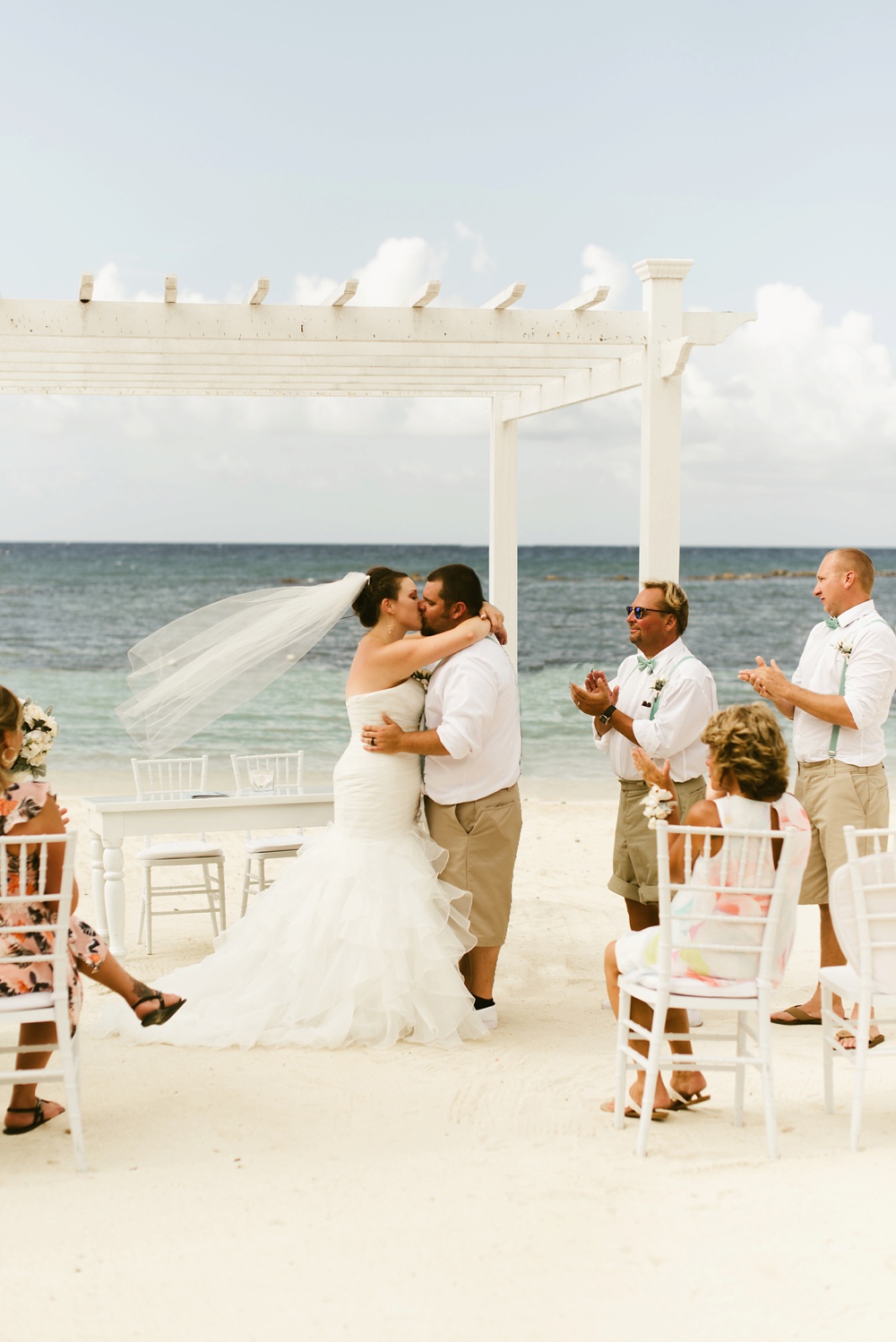 bride and groom kiss at oceanside ceremony at grand palladium jamaica wedding