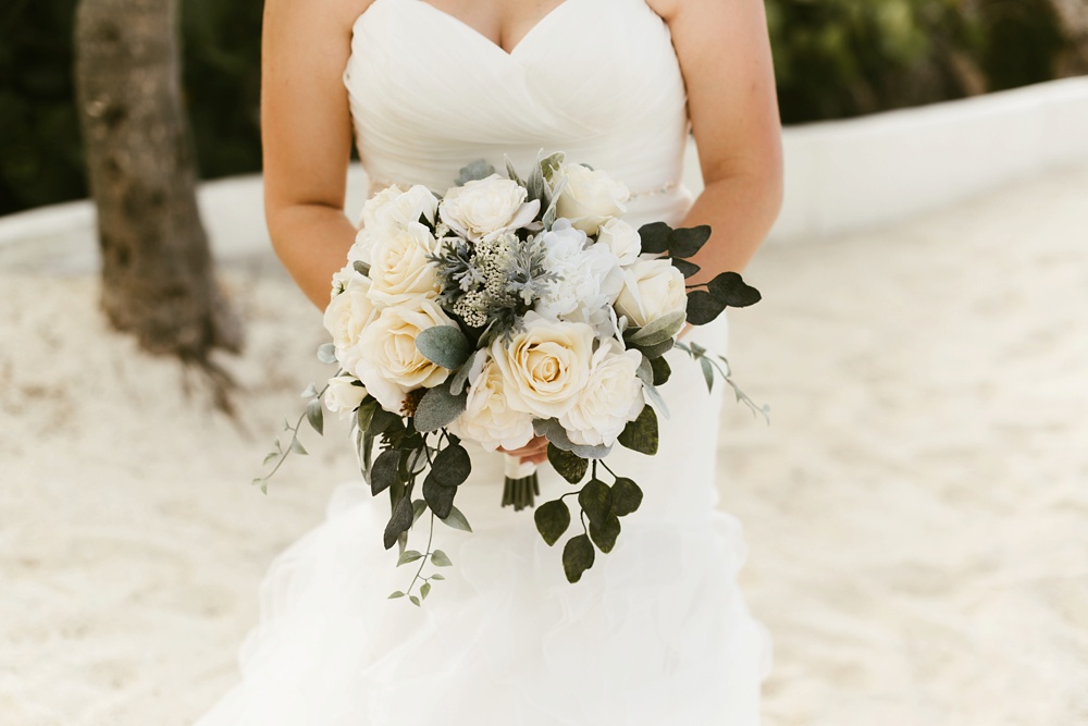 bride with white rose bouquet and davids bridal dress at grand palladium jamaica wedding