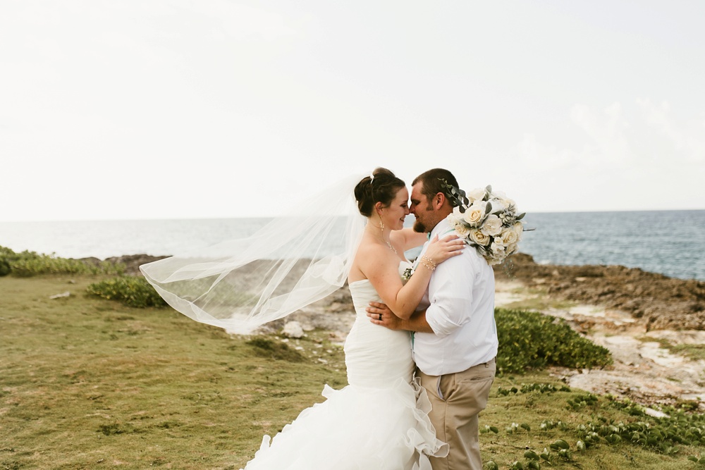 bride and groom hugging oceanside at grand palladium jamaica wedding