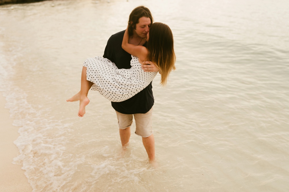husband carrying wife on beach grand palladium jamaica
