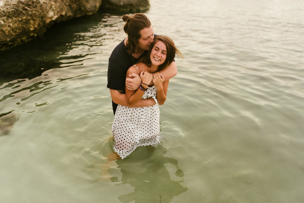 husband kissing wife in water at grand palladium jamaica