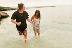 couple holding hands in ocean water at grand palladium jamaica