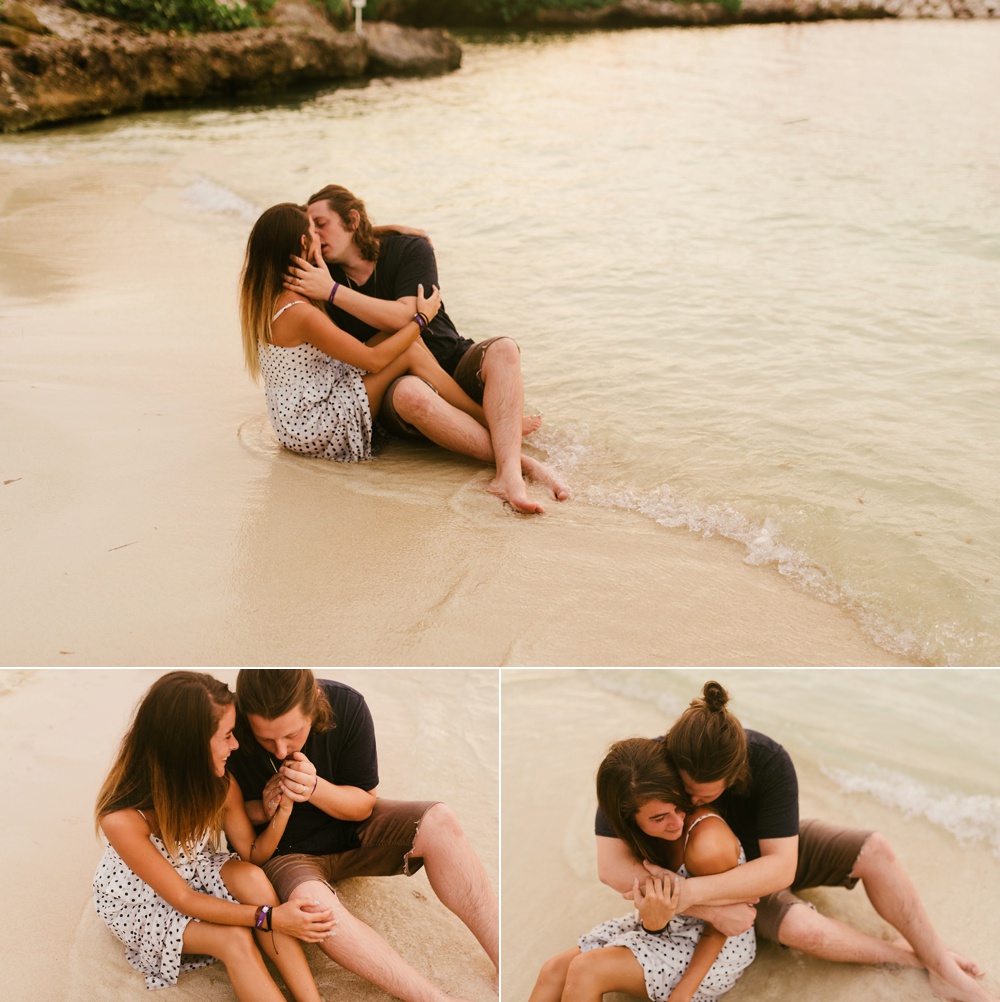 couple kissing on beach next to ocean at grand palladium jamaica