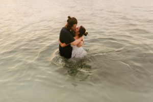 couple kissing in ocean water at grand palladium jamaica