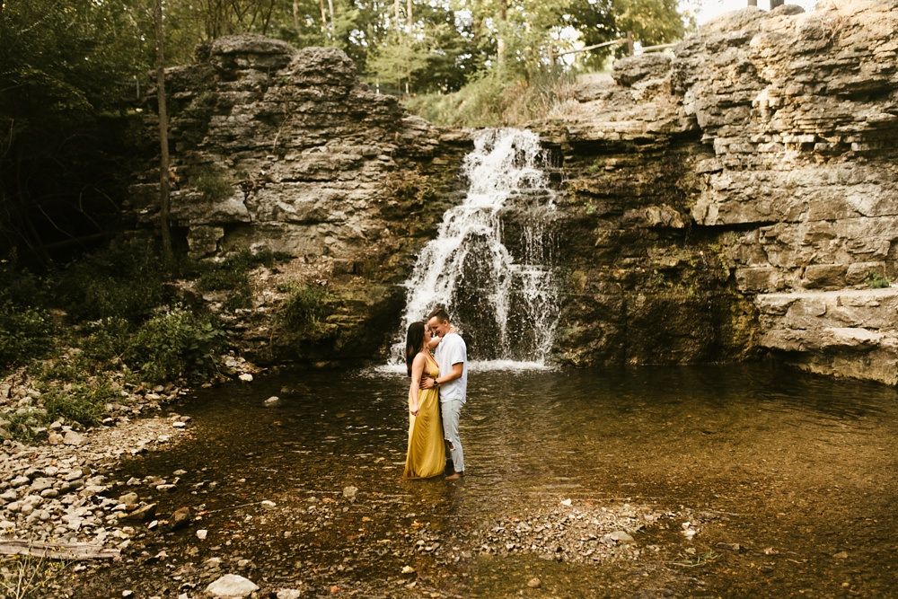 couple dancing in water at indiana waterfall engagement photoshoot