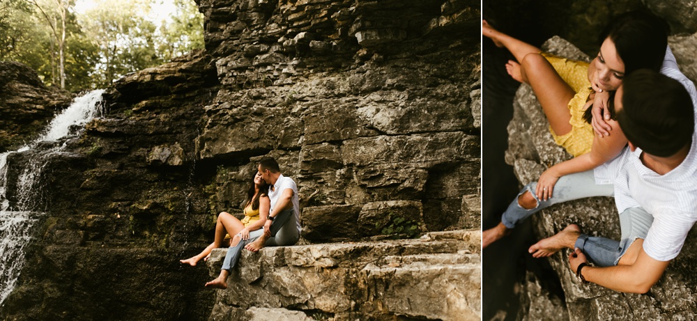 couple sitting on ledge of waterfall at indiana waterfall engagement photoshoot