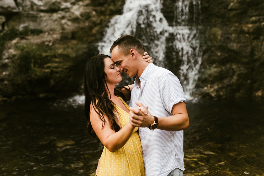 couple slow dancing at indiana waterfall engagement photoshoot