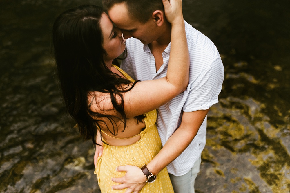 couple hugging at indiana waterfall engagement photoshoot