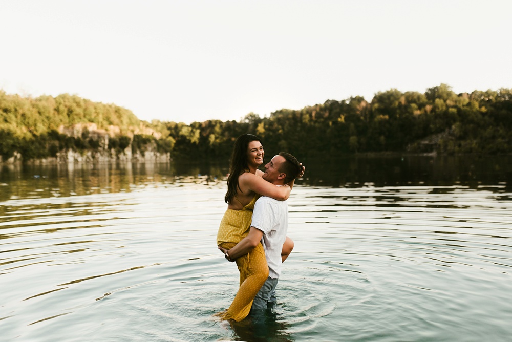 couple hugging and laughing at indiana waterfall engagement photoshoot