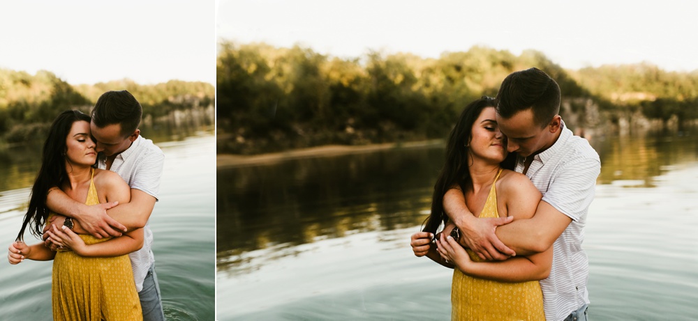couple standing in water at indiana waterfall engagement photoshoot
